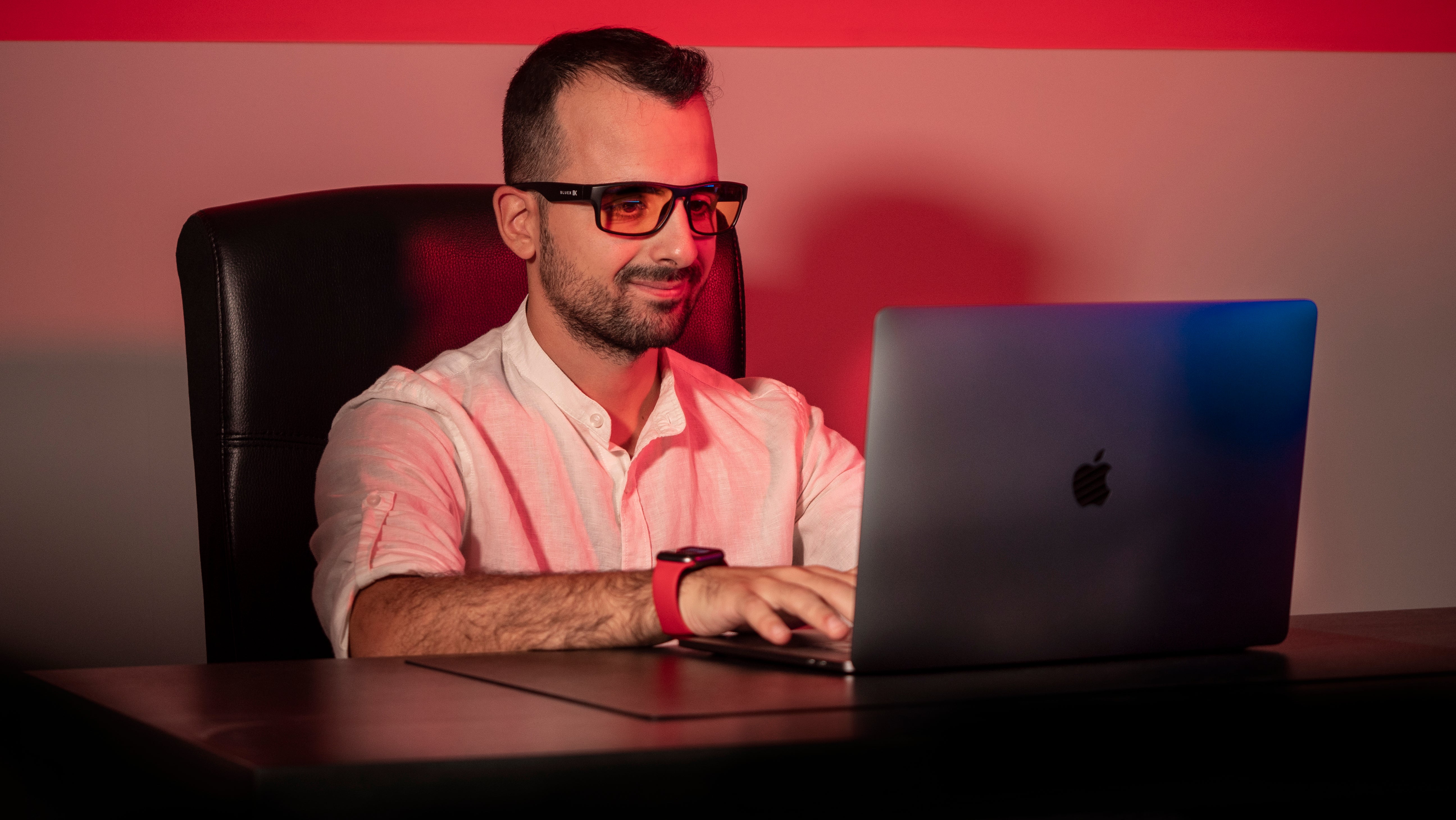 Un ragazzo indossa occhiali BlueX mentre usa il computer